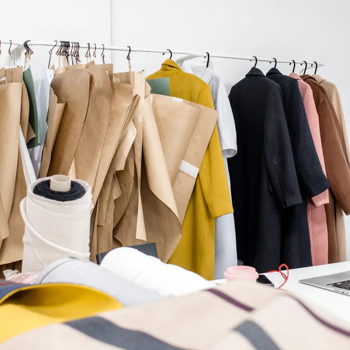 Clothing patterns, fabrics and finished garments in a fashion design atelier